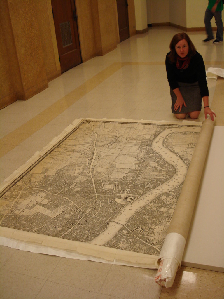 Holly Prochaska getting ready to roll, literally and figuratively.  With the map released from stretcher, the linen backed sheets are rolled onto a supportive structure for transport.  