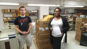 Alex and Hyacinth unpacking a shipment from the commercial bindery