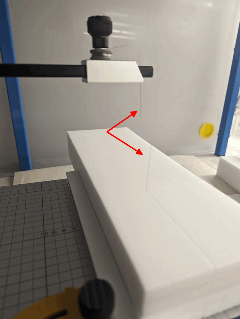 Image of a snapped cutting wire caused by applying to much pressure, and not enough heat, while cutting a foam block.