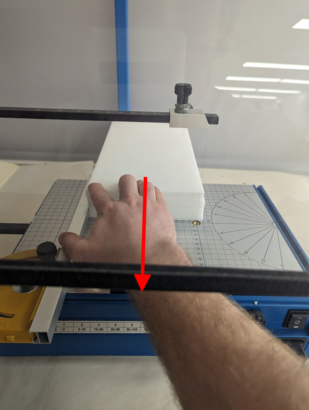 Image of foam plank being cut by a the hot filament of the Hercules foam cutter.