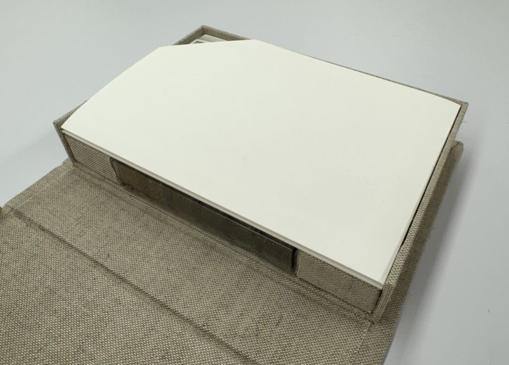 Cloth clamshell with insert and small book inside