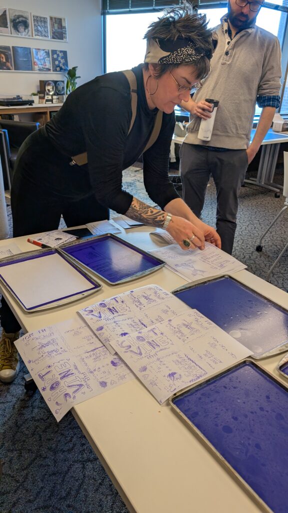 Image of workshop instructor Leisha copying zines on the gelatin matrix.